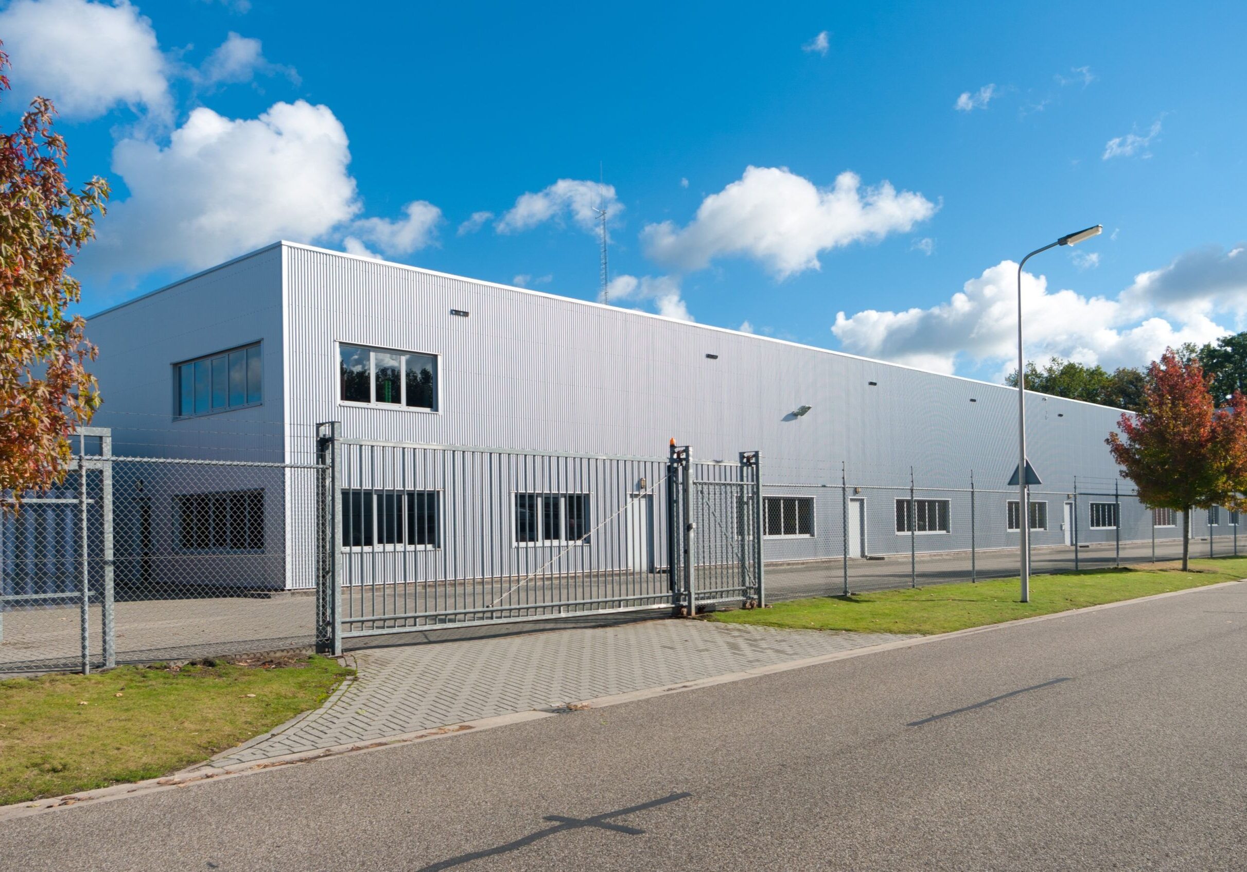 Modern,Exterior,Of,An,Industrial,Building,,Surrounded,By,A,Fence